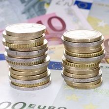 zu Türmen gestapelte Euromünzen, darunter Euroscheine